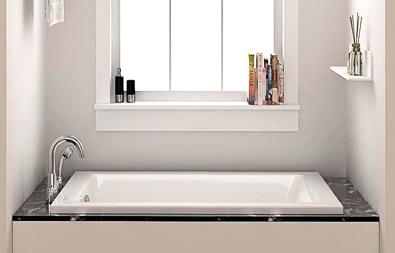 A bathtub installed in a bathroom.